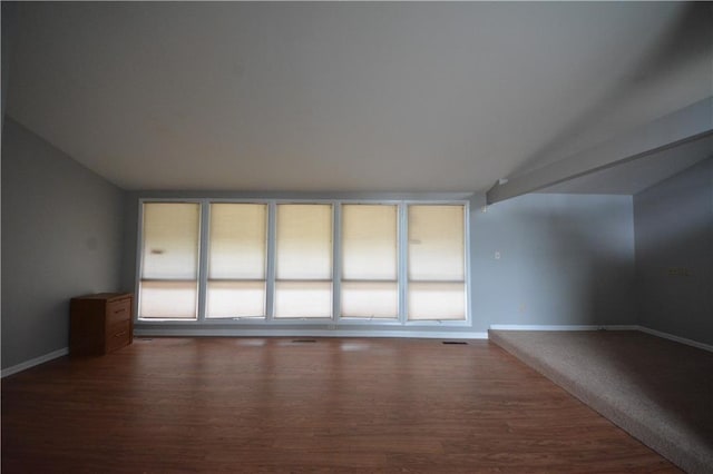 empty room with dark wood-type flooring