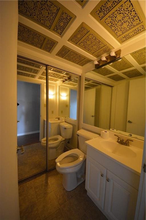 bathroom featuring tile flooring, toilet, and large vanity