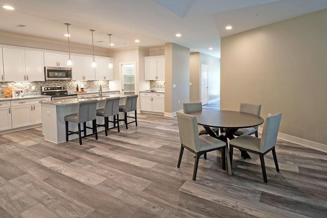 dining area featuring sink and hardwood / wood-style flooring