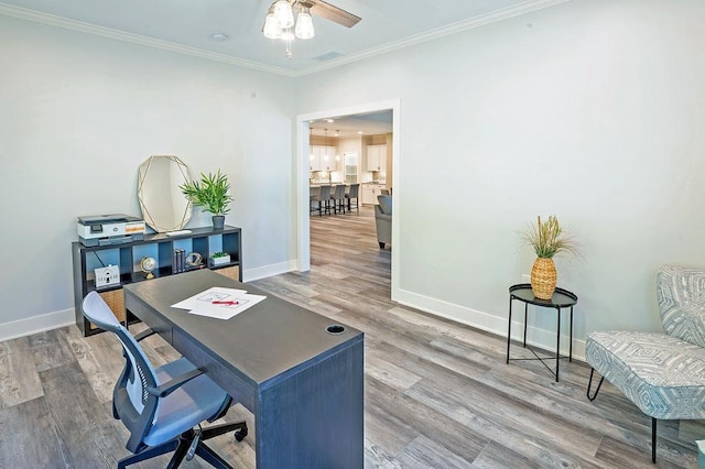 home office featuring hardwood / wood-style floors, ornamental molding, and ceiling fan