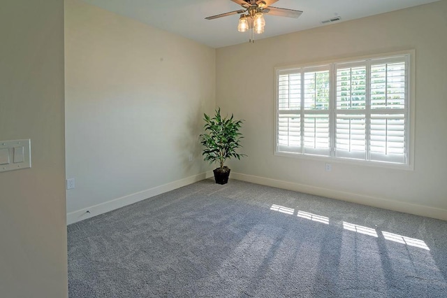 empty room with ceiling fan and light carpet