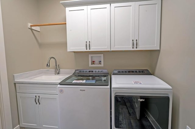 washroom featuring cabinets, separate washer and dryer, sink, and hookup for a washing machine