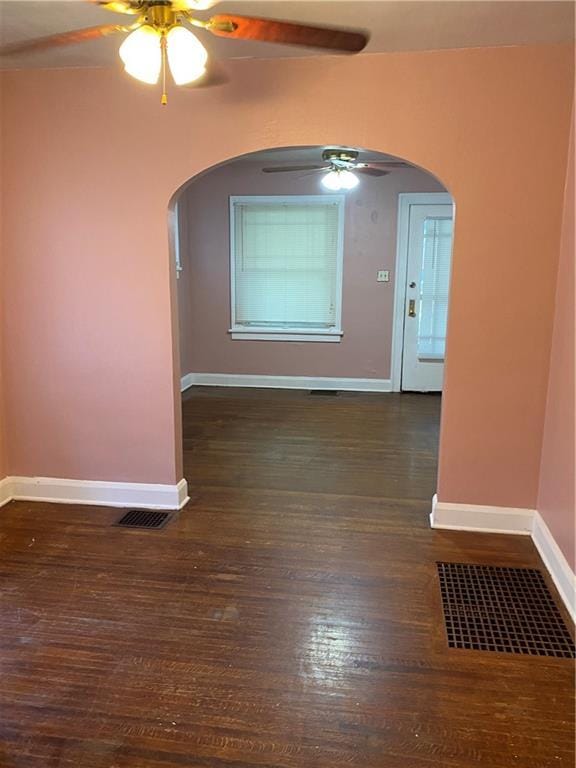 spare room with dark hardwood / wood-style floors and ceiling fan