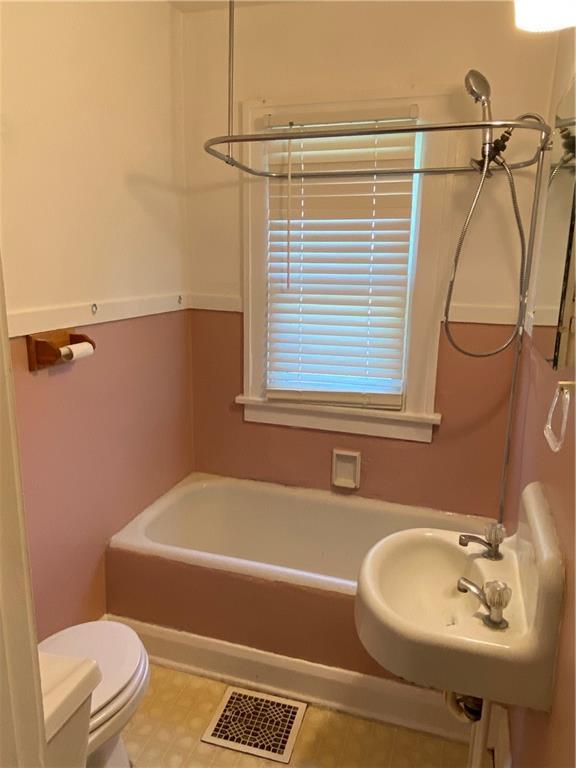 full bathroom featuring tub / shower combination, tile flooring, sink, and toilet