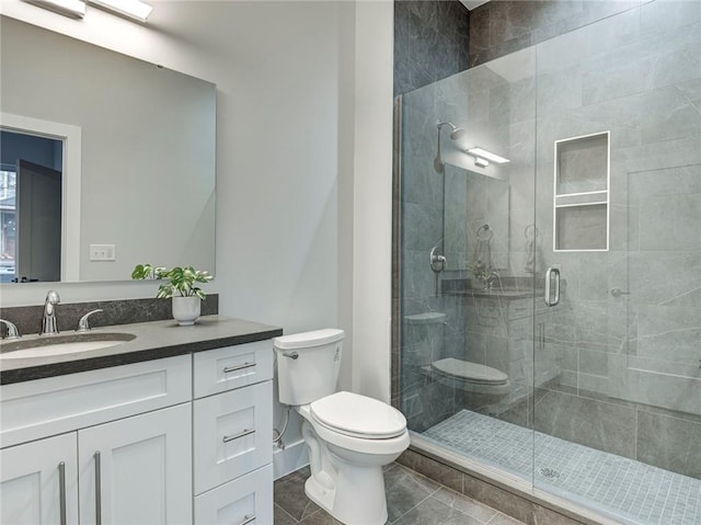 bathroom featuring vanity, tile floors, a shower with door, and toilet