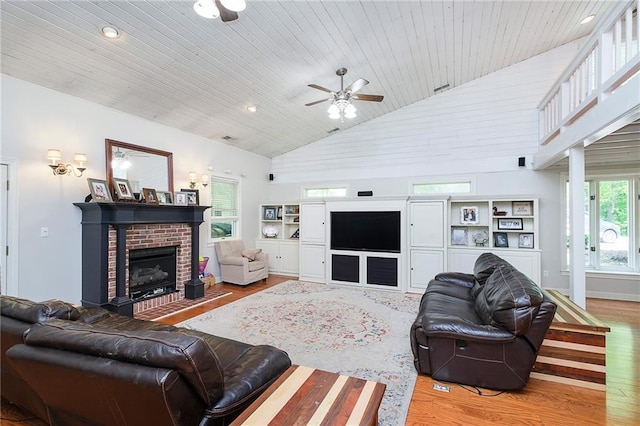 living room with wood ceiling, light hardwood / wood-style floors, ceiling fan, and high vaulted ceiling