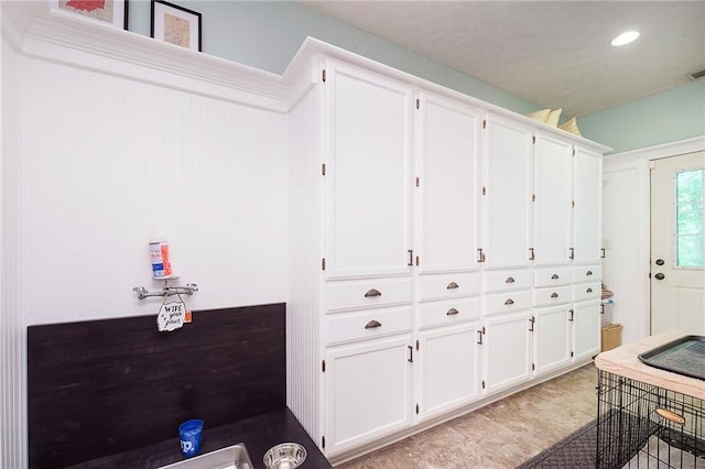 kitchen featuring white cabinets