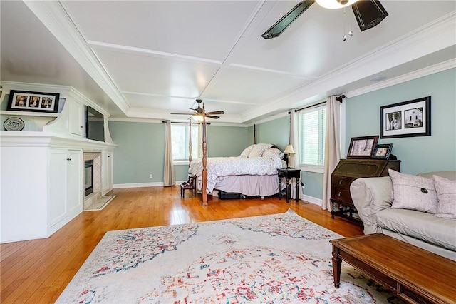 bedroom with crown molding, light hardwood / wood-style floors, and ceiling fan