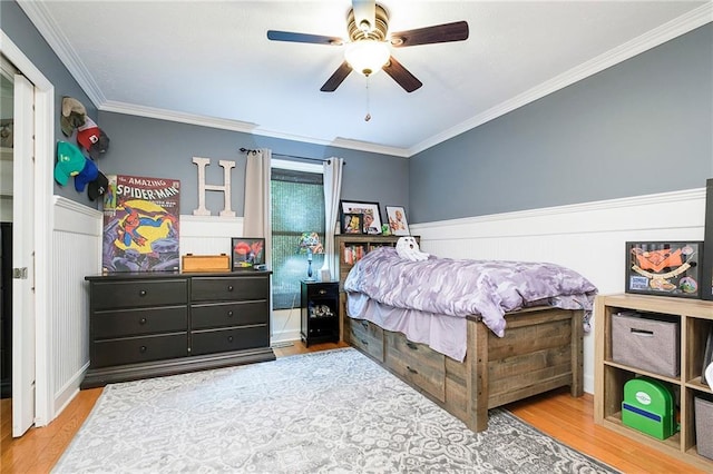 bedroom featuring ornamental molding, ceiling fan, and hardwood / wood-style flooring