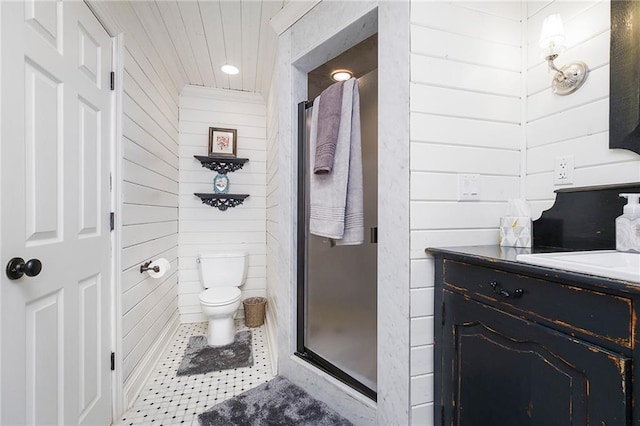 bathroom featuring vanity, toilet, and a shower with shower door