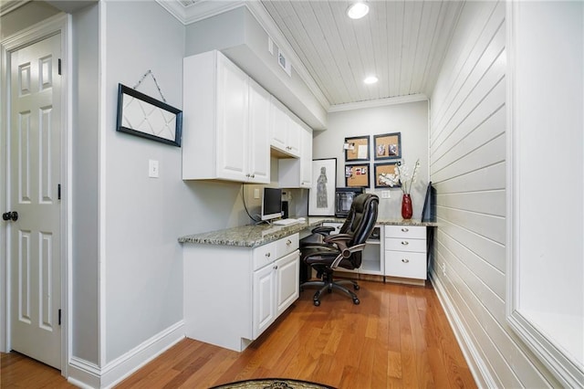 office space with ornamental molding, wood ceiling, built in desk, and light hardwood / wood-style floors