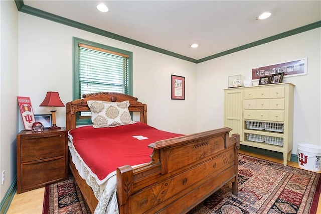 bedroom featuring crown molding and light hardwood / wood-style floors