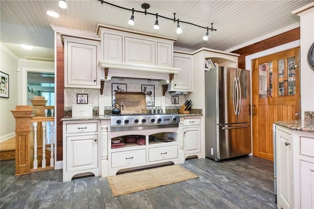 kitchen with tasteful backsplash, stone counters, stainless steel appliances, crown molding, and dark hardwood / wood-style flooring