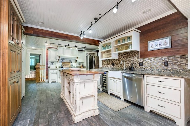 kitchen featuring tasteful backsplash, dark hardwood / wood-style flooring, stainless steel appliances, beverage cooler, and a center island