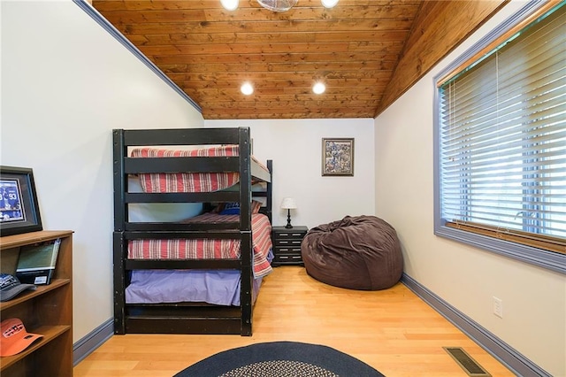 bedroom with wooden ceiling, lofted ceiling, and hardwood / wood-style floors