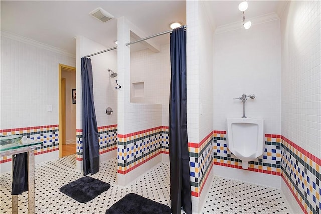 bathroom featuring tile walls, walk in shower, and crown molding