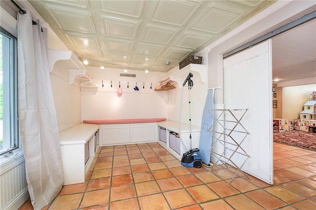 interior space featuring light tile patterned flooring and white cabinetry