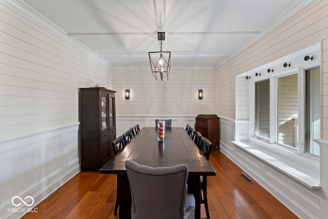 dining space featuring crown molding and dark hardwood / wood-style flooring