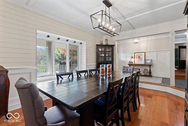 dining space with a chandelier and hardwood / wood-style flooring