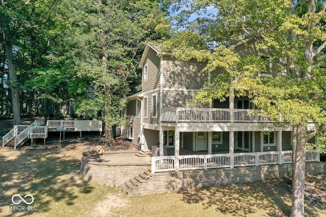 rear view of property featuring a wooden deck