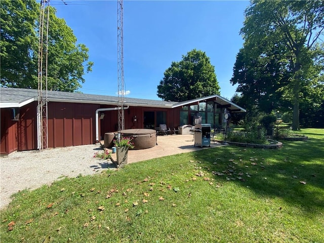 back of property with a patio area and a lawn