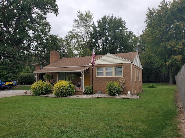 view of front of home with a porch and a front lawn