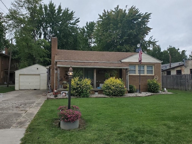 view of front of home featuring a garage, an outdoor structure, and a front lawn