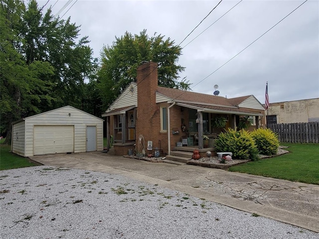 rear view of house with a garage, an outdoor structure, and a lawn