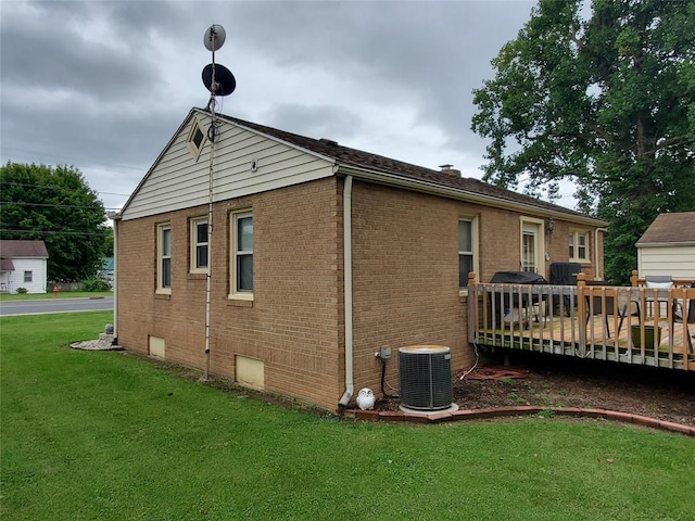 rear view of property featuring a yard, central AC, and a deck