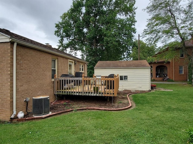 back of house with a wooden deck, a yard, and central AC