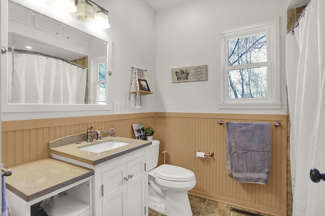 bathroom featuring toilet, tile floors, and large vanity