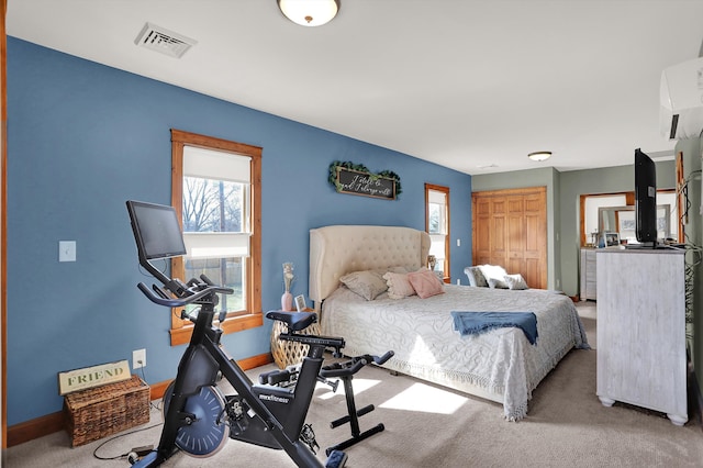 bedroom with light carpet and a closet