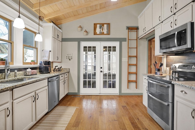 kitchen featuring white cabinetry, beamed ceiling, appliances with stainless steel finishes, sink, and wood ceiling