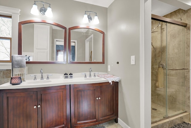 bathroom with double sink, tile floors, large vanity, and walk in shower