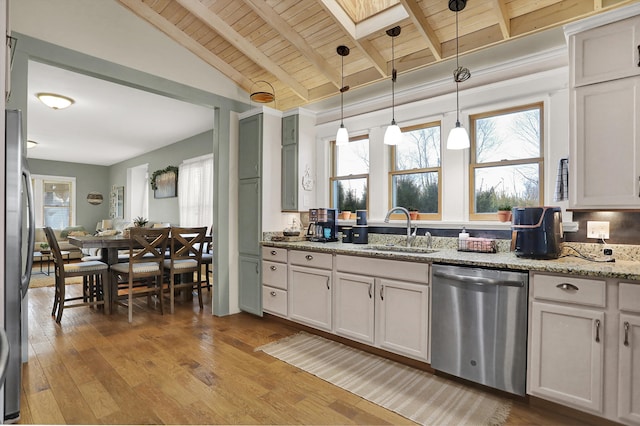 kitchen featuring appliances with stainless steel finishes, decorative light fixtures, plenty of natural light, and sink