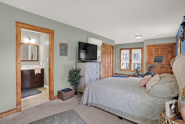 carpeted bedroom with sink and ensuite bath