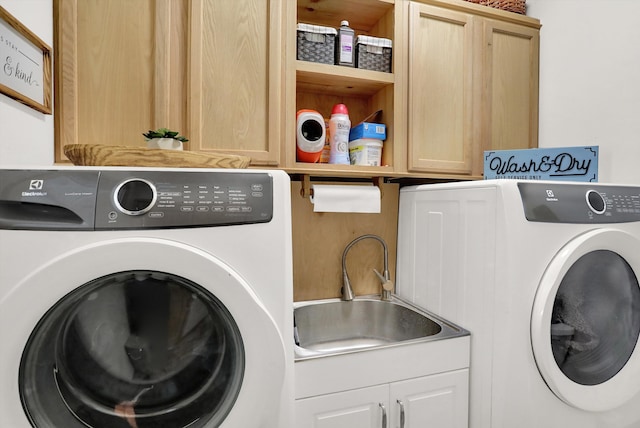 laundry room featuring cabinets, sink, and washing machine and dryer