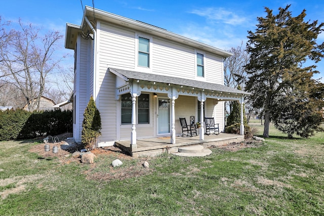 back of house with a lawn