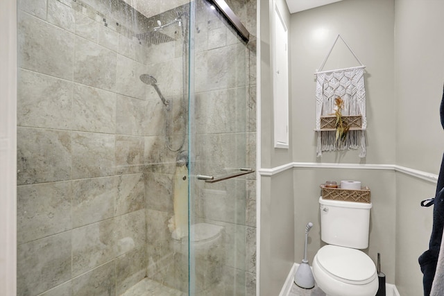 bathroom featuring walk in shower and toilet