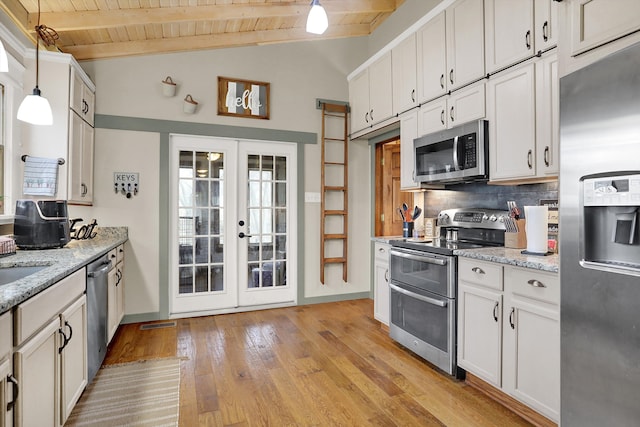 kitchen featuring pendant lighting, wood ceiling, appliances with stainless steel finishes, beam ceiling, and tasteful backsplash