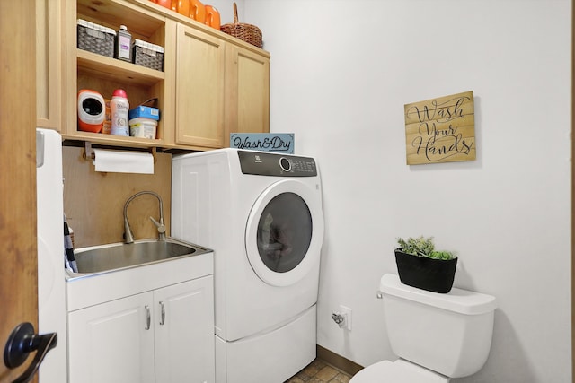 clothes washing area featuring light tile floors, washer / clothes dryer, cabinets, and sink