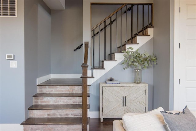 stairway featuring dark wood-type flooring