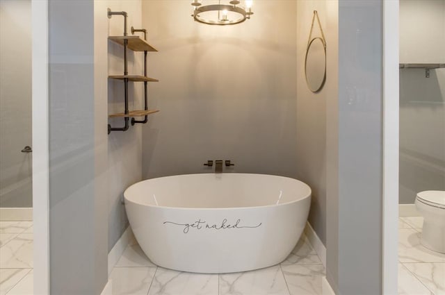 bathroom featuring an inviting chandelier, toilet, and tile floors