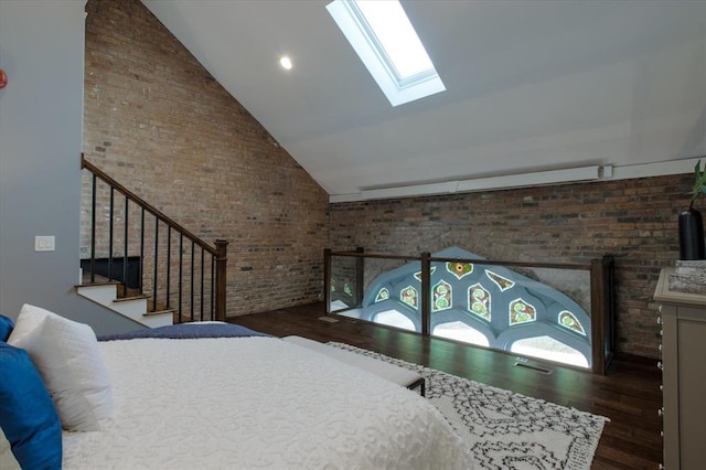 bedroom featuring a skylight, brick wall, dark wood-type flooring, and high vaulted ceiling