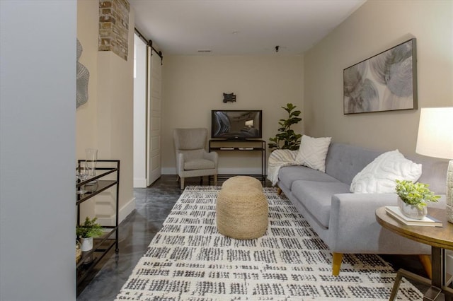 living room with brick wall and a barn door