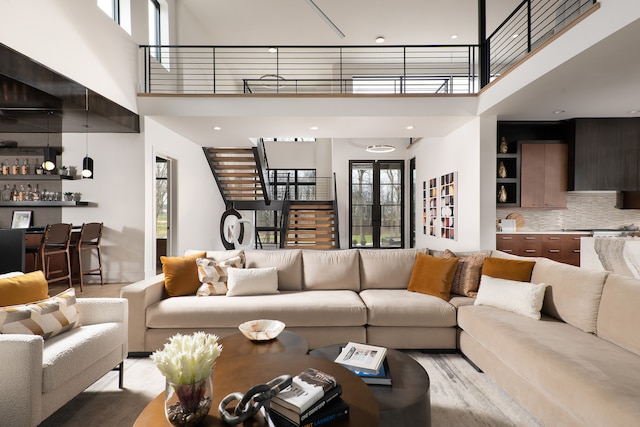 living room featuring a high ceiling and light wood-type flooring