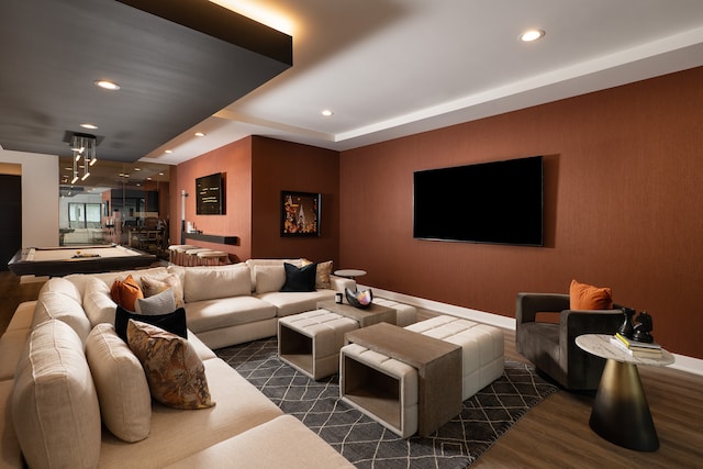 living room featuring an inviting chandelier and dark wood-type flooring