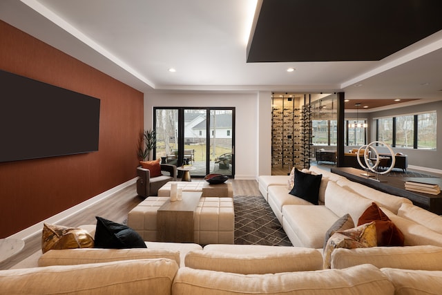 home theater room featuring an inviting chandelier and wood-type flooring