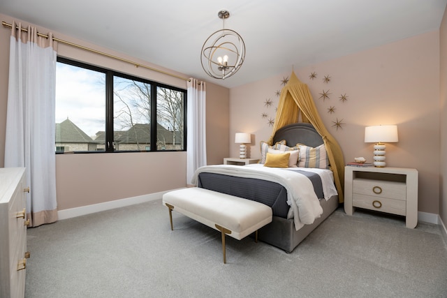 carpeted bedroom with an inviting chandelier