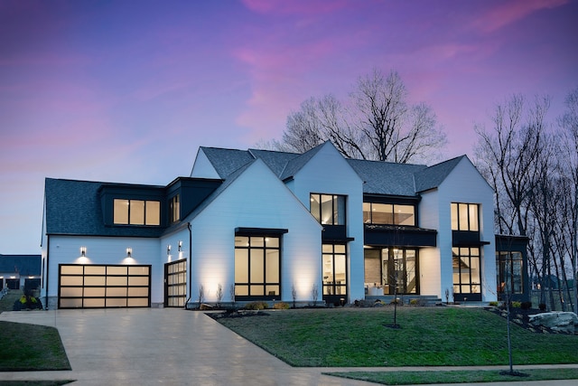 view of front of property with a yard and a garage